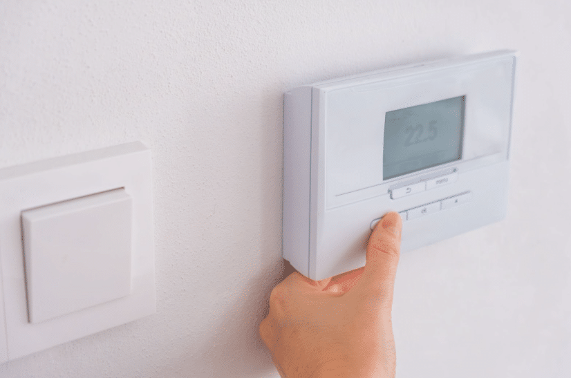Someone changing the temperature of their at home thermostat
